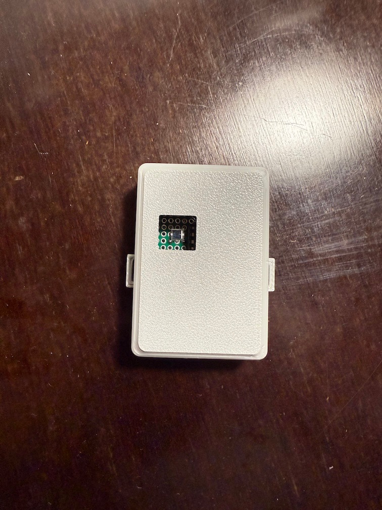 A small white 3D-printed enclosure with a window through which the photodiode is visible.